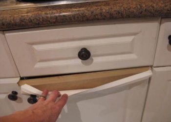 How do you fix peeling laminate on kitchen cabinets?