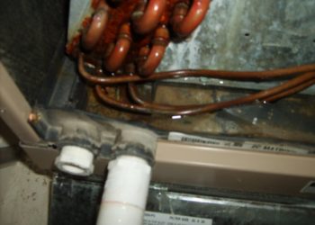blowing compressed air into clogged drain