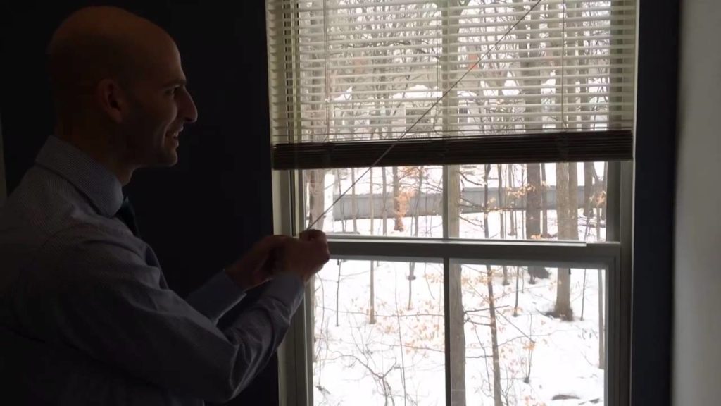 How do you lower cordless blinds?