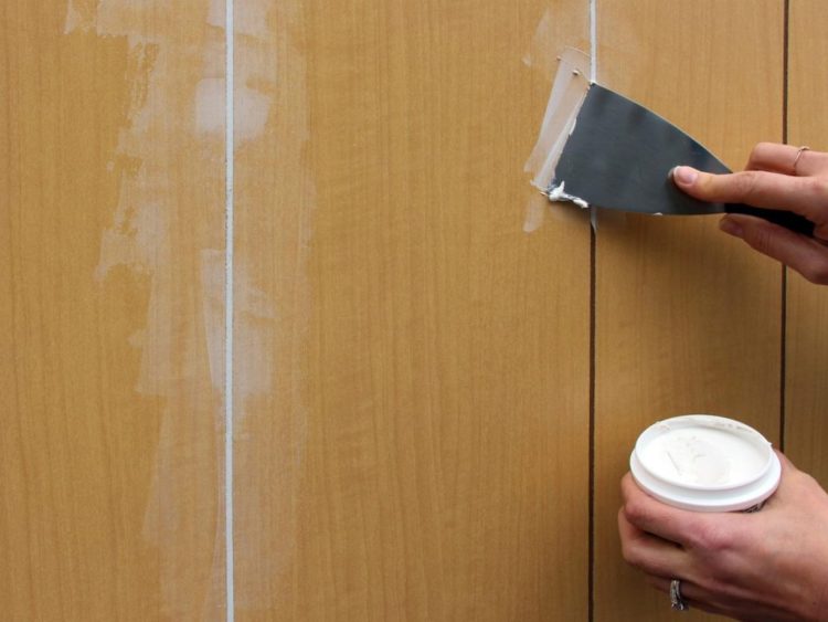 How do you glue wall paneling?