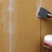 How do you glue wall paneling?