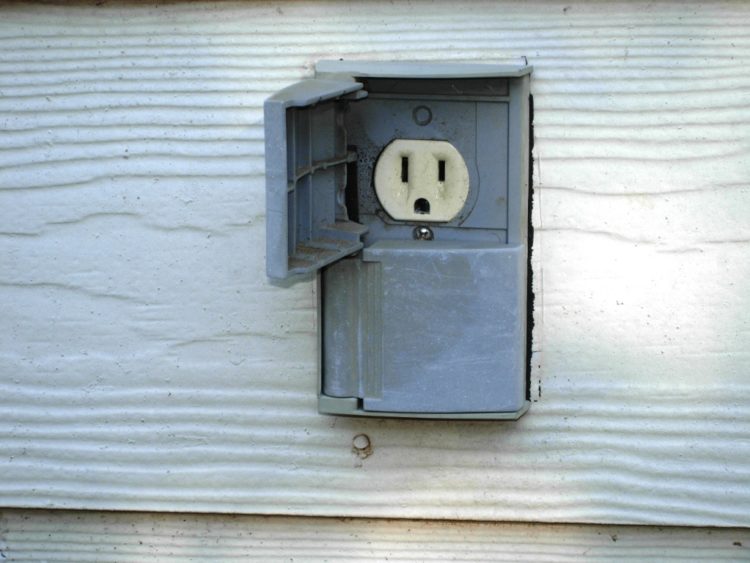 How do you protect an outdoor electrical outlet?