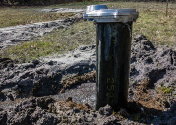 water coming out top of well cap