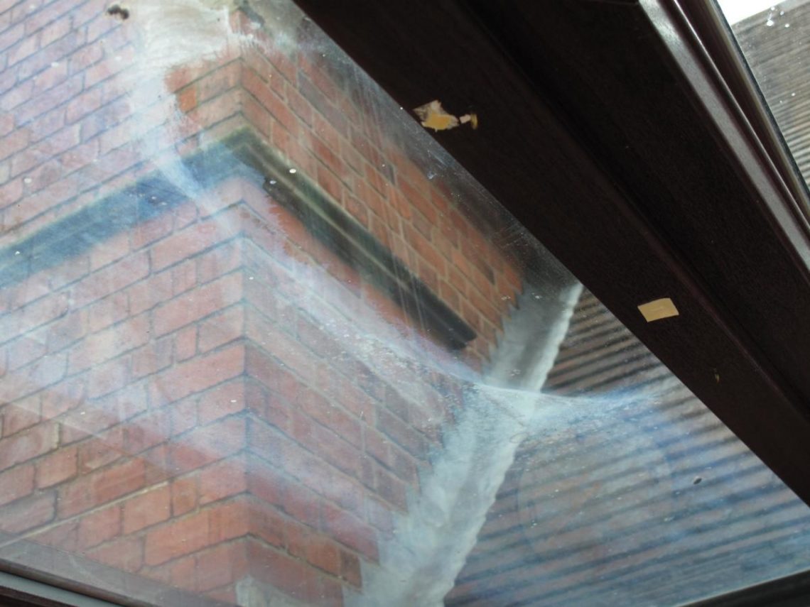 How do you remove dried water stains from glass?