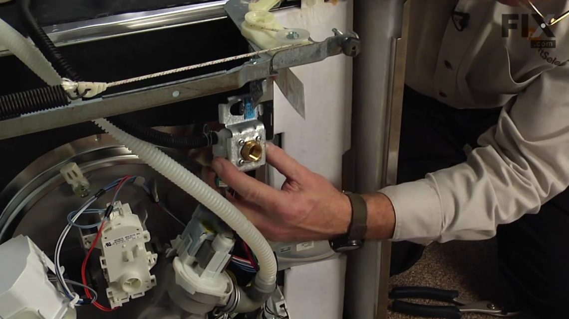 How do you remove the water inlet valve from a dishwasher?