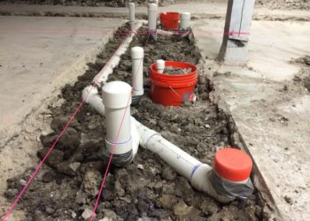 How do you break down a concrete slab for plumbing?