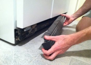 How do I clean the bottom of my Whirlpool refrigerator?