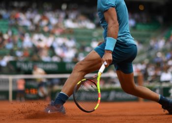 How are clay courts maintained?