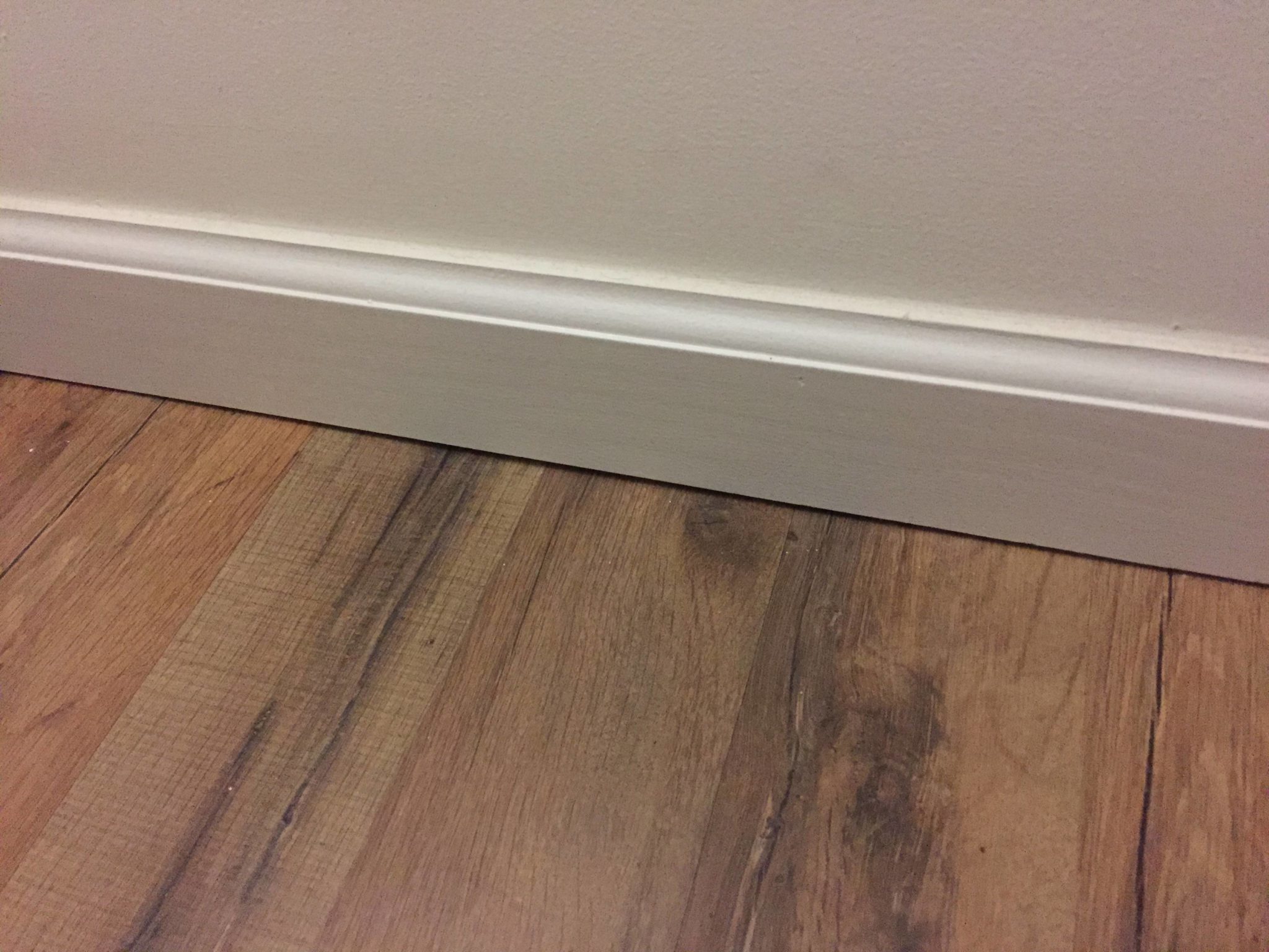 How do you seal a gap between baseboard and floor?