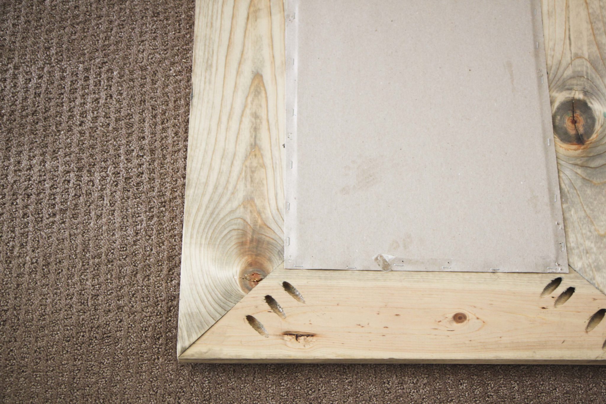 How do you secure a mirror in a wooden frame?