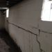 What is the proper fix for a bowing basement wall?