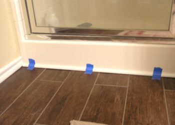 How do you finish vinyl flooring around a bathtub?