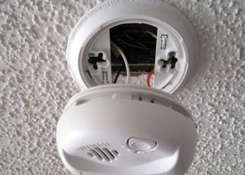 How do you stop a hardwired smoke detector from going off?