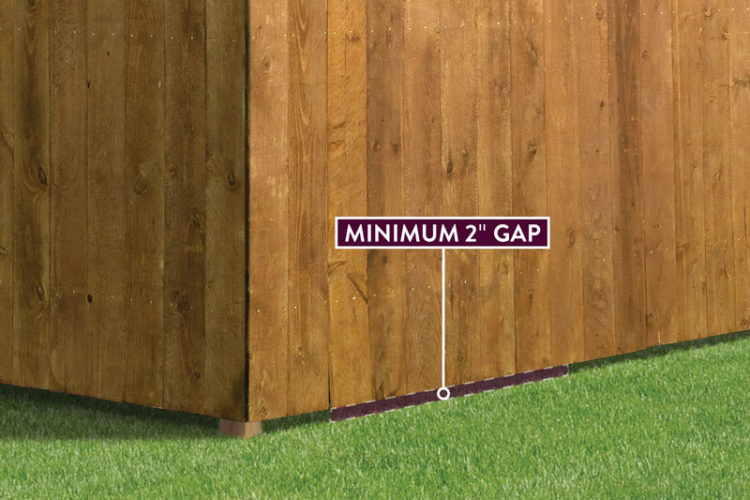 Should a vinyl fence touch the ground?