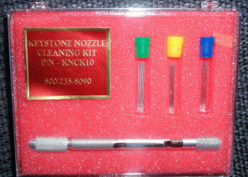 How do you clean Nordson glue nozzles?