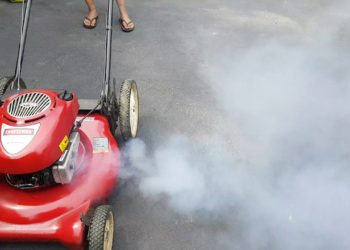 lawn mower blows oil out carburetor