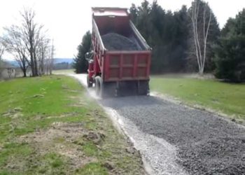 spreading stone on driveway