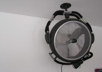 Where should a fan be placed in a garage?